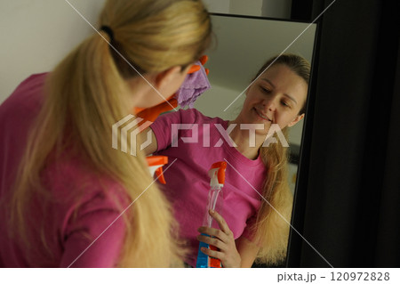 A woman is cleaning her living room at home A woman is cleaning her living room at home 120972828