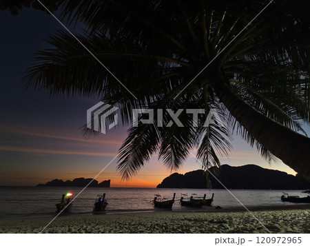 A stunning sunset is casting vibrant hues of color over a tranquil ocean A stunning sunset is casting vibrant hues of color over a tranquil ocean 120972965