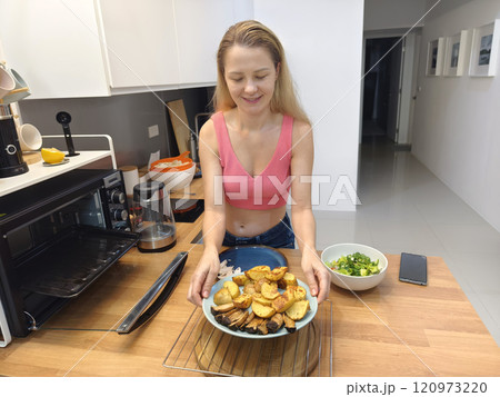A young woman prepares a fresh meal  120973220