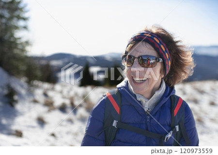 Winter hike for an elderly man in snowy mountains. Active senior enjoying nature. 120973559