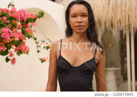 Summer Fashion. Woman Posing Outdoors with Vibrant Pink Flowers in Background 120973945