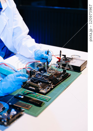 The technician is putting the CPU on the socket of the computer motherboard. electronic engineering The technician is putting the CPU on the socket of the computer motherboard. electronic engineering 120973967