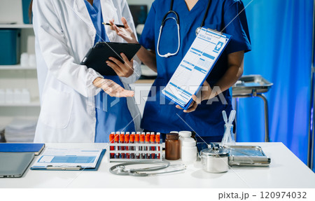 scientists in lab coats conducting research, handling glassware, and working with chemicals 120974032