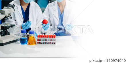 scientists in lab coats conducting research, handling glassware, and working with chemicals 120974040