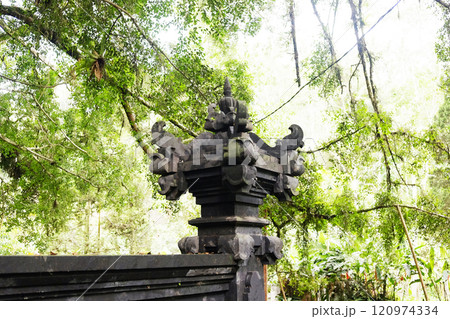 Ancient black stucco and sculpture decoration on the capital of an entrance in a Hindu temple of Hinduism on Bali Island of Indonesia. Travel destination for culture and religion of Asian Ancient black stucco and sculpture decoration on the capital of an entrance in a Hindu temple of Hinduism on Bali Island of Indonesia. Travel destination for culture and religion of Asian 120974334