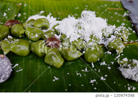 Klepon Tanah Lot is Indonesian traditional food or dessert made of sweet rice powder filled with coconut crumble and brown sugar on banana leaf. Street food in Bali 120974398