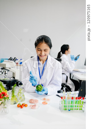 Food science as lab scientists test and analyze vegetables for safety and quality using advanced technology 120975165