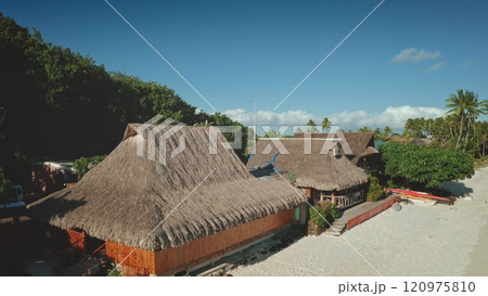 Luxury hotel huts bungalows in Bora Bora, French Polynesia. Tropical island beach lagoon tranquil escape. Perfect summer holiday, remote wild nature paradise, exotic travel. Aerial zoom out panorama 120975810