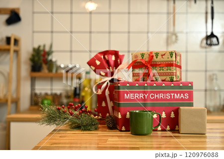 Beautiful Christmas gift boxes, coffee mug and festive decor on wooden countertop Beautiful Christmas gift boxes, coffee mug and festive decor on wooden countertop 120976088