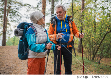 Hiking tourism adventure. Senior couple man woman enjoying outdoor recreation hiking in forest. Happy old people backpackers hikers enjoy walking hike trekking tourism active vacation beauty of nature 120976899