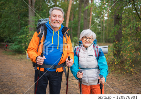 Hiking tourism adventure. Senior couple man woman enjoying outdoor recreation hiking in forest. Happy old people backpackers hikers enjoy walking hike trekking tourism active vacation beauty of nature 120976901