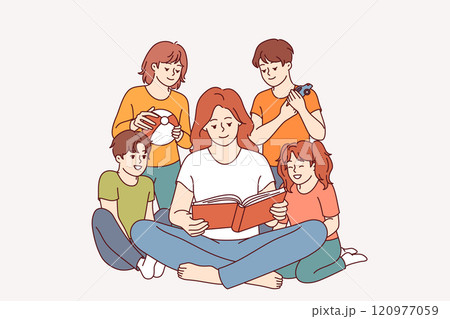 Woman kindergarten teacher reads book to children who are listening with interest to new fairy tale 120977059