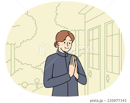 Woman in thai national clothes says hello standing at entrance to old asian temple 120977141