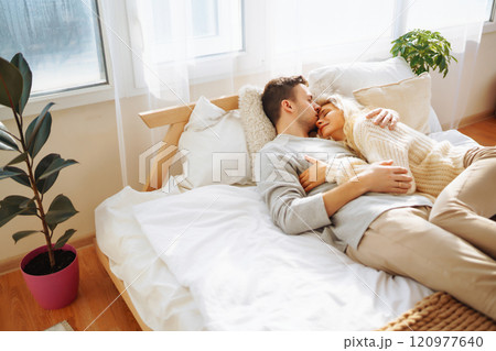 Couple in love relaxing at home on the bed while they hug each other and having fun. Valentine's Day 120977640
