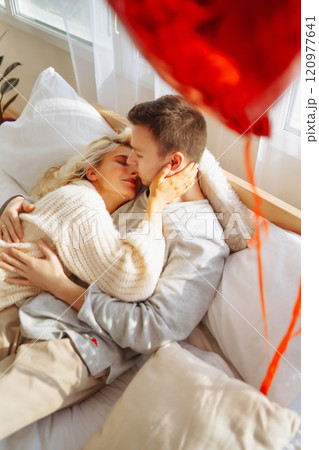 Couple in love relaxing at home on the bed while they hug each other and having fun. Valentine's Day 120977641