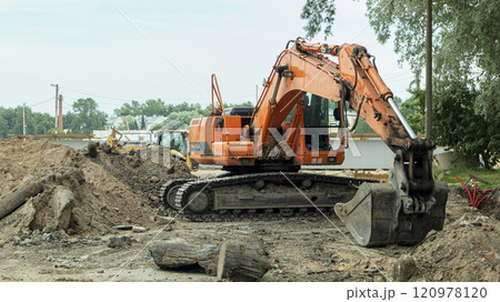 orange construction excavator near the construction site 120978120
