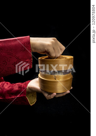 Chinese person showing dim sum dumpling on bamboo wooden basket bowl Chinese person showing dim sum dumpling on bamboo wooden basket bowl 120978804