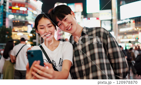 Couple, selfie and night in city with smile for date, memory and travel with bonding for post on web. People, woman and man with photography, happy and profile picture on social network in Japan Couple, selfie and night in city with smile for date, memory and travel with bonding for post on web. People, woman and man with photography, happy and profile picture on social network in Japan 120978870