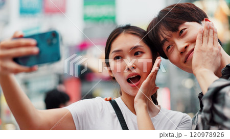 City, selfie and wow with couple on street together in Japan for bonding, love or tourism. Happy, photograph and surprise of Japanese woman with man in urban town for holiday, travel or vacation 120978926