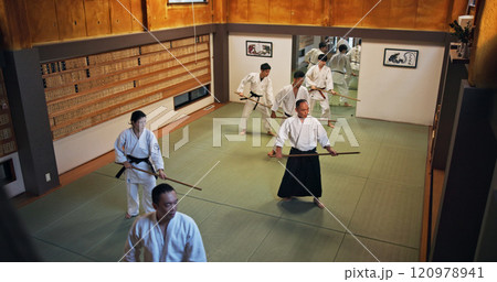 Dojo, group class and Aikido training in gym with wood sword Japanese martial arts and fight exercise in wellness studio. Learning, sport and bamboo weapon with people and strike practice for defence Dojo, group class and Aikido training in gym with wood sword Japanese martial arts and fight exercise in wellness studio. Learning, sport and bamboo weapon with people and strike practice for defence 120978941