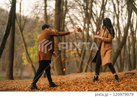 Young couple in love walking in the park on a autumn day. Enjoying time together. 120979079