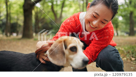 Nature, laugh and woman with dog in forest for bonding, companion and love for adoption. Happy, connection and Japanese female person with beagle puppy for pet outdoor in woods for playing together. 120979135