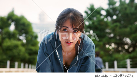Portrait, tired and woman for fitness with earphones, sport exercise and listen to music of workout recovery. Female athlete, fatigue and break of cardio training, resting and podcast on Japan bridge 120979278