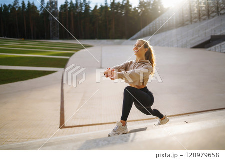 Active lifestyle. Young fitness woman exercising and stretching outdoors. Sports, sports training. Active lifestyle. Young fitness woman exercising and stretching outdoors. Sports, sports training. 120979658