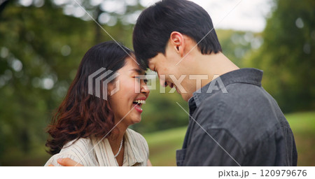 Happy couple laugh, love and forehead touch outdoor for loyalty, funny or support together. Japanese man, woman and romantic relationship at park for connection, care or trust on valentines day date 120979676