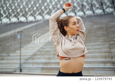 Active lifestyle. Young fitness woman exercising and stretching outdoors. Sports, sports training. Active lifestyle. Young fitness woman exercising and stretching outdoors. Sports, sports training. 120979745