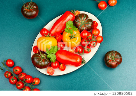 Fresh tomatoes on a plate. 120980592