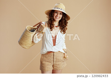 happy trendy housewife in blouse and shorts isolated on beige 120982433