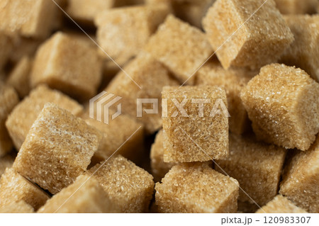 Macro cubes of brown cane unrefined dry demerara sugar. 120983307