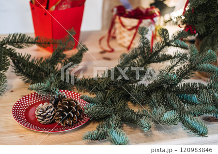 Simple DIY Christmas decor with pinecones and greenery on a red polka dot plate. Perfect for beginner-friendly holiday crafting ideas. Simple DIY Christmas decor with pinecones and greenery on a red polka dot plate. Perfect for beginner-friendly holiday crafting ideas. 120983846