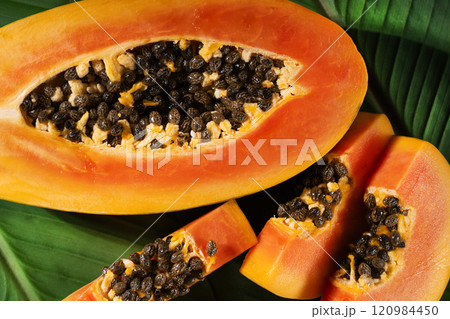 Juicy papaya fruit slices top view. Tropical papaya fruit background. Papaya fruit closeup. Juicy papaya fruit slices top view. Tropical papaya fruit background. Papaya fruit closeup. 120984450