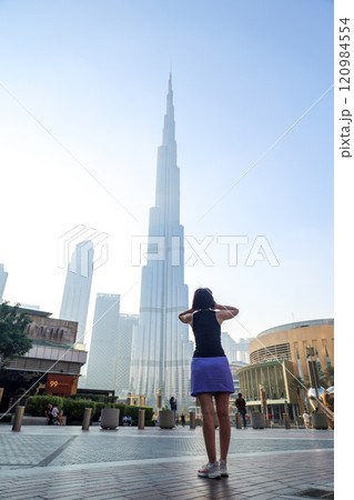 Dubai, United Arab Emirates - September 25, 2024 A female tourist poses in front of the world's tallest skyscraper, Burj Khalifa. Editorial Dubai, United Arab Emirates - September 25, 2024 A female tourist poses in front of the world's tallest skyscraper, Burj Khalifa. Editorial 120984554