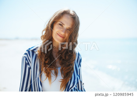 happy elegant woman on ocean coast enjoying peace of mind happy elegant woman on ocean coast enjoying peace of mind 120985945
