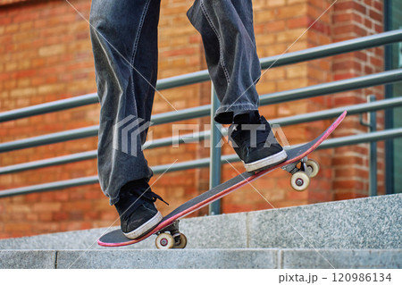 Skateboarder Performing Trick on Urban Street Skateboarder Performing Trick on Urban Street 120986134