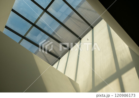 Abstract, minimalist, modern architectural space with concrete walls and opening skylight 120986173