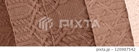Demonstrating the colors of 2025 - Mocha Mousse. Knitted abstract background in different shades in trendy colors 2025. Large knitted blanket or sweater with pattern. Color concept. Banner 120987542