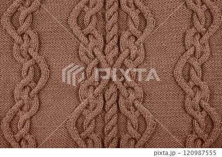 Demonstrating the colors of 2025 - Mocha Mousse. Knitted brown background. Large knitted fabric with a pattern. Close-up of a knitted blanket. Color concept. 120987555
