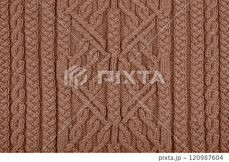 Demonstrating the colors of 2025 - Mocha Mousse. Knitted brown background. Large knitted fabric with a pattern. Close-up of a knitted blanket. Color concept. Demonstrating the colors of 2025 - Mocha Mousse. Knitted brown background. Large knitted fabric with a pattern. Close-up of a knitted blanket. Color concept. 120987604