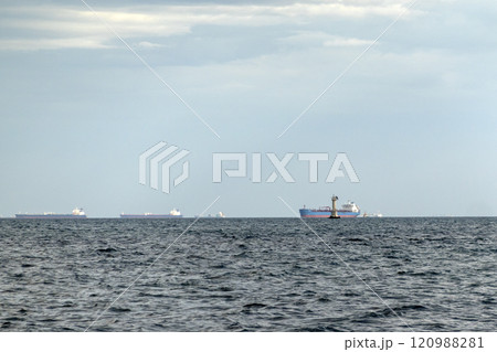 Sea freighter sailing in the middle of the ocean with big waves Sea freighter sailing in the middle of the ocean with big waves 120988281