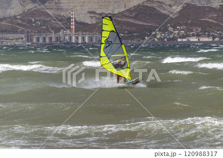 A kite surfer rides and jumps the waves the black sea 120988317
