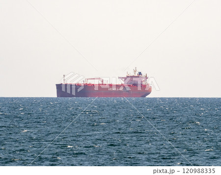 Sea freighter sailing in the middle of the ocean with big waves Sea freighter sailing in the middle of the ocean with big waves 120988335