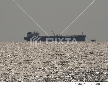 Sea freighter sailing in the middle of the ocean with big waves Sea freighter sailing in the middle of the ocean with big waves 120988336