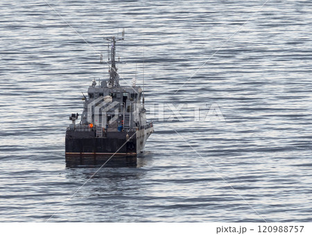 Sea freighter sailing in the middle of the ocean with big waves Sea freighter sailing in the middle of the ocean with big waves 120988757