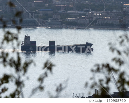 Sea freighter sailing in the middle of the ocean with big waves 120988760