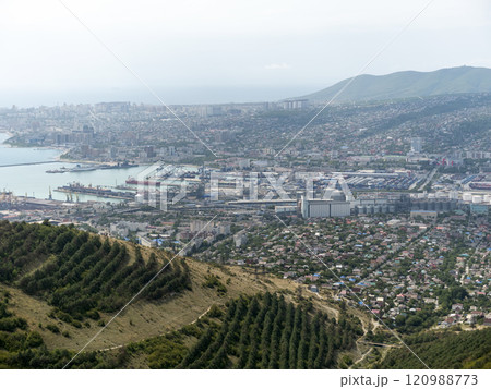 Panoramic view of Novorossiysk City and Tsemess Bay at sunrise. Morning cityscape of large port at Black Sea coast in Russia Panoramic view of Novorossiysk City and Tsemess Bay at sunrise. Morning cityscape of large port at Black Sea coast in Russia 120988773