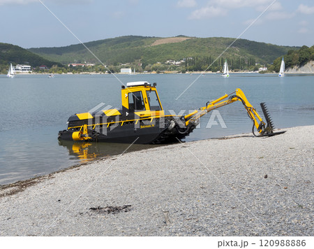 Abrau Durso, Russia 28 August 2024: Municipal aquatic weed harvesting equipment passes along lake Abrau-Durso 120988886